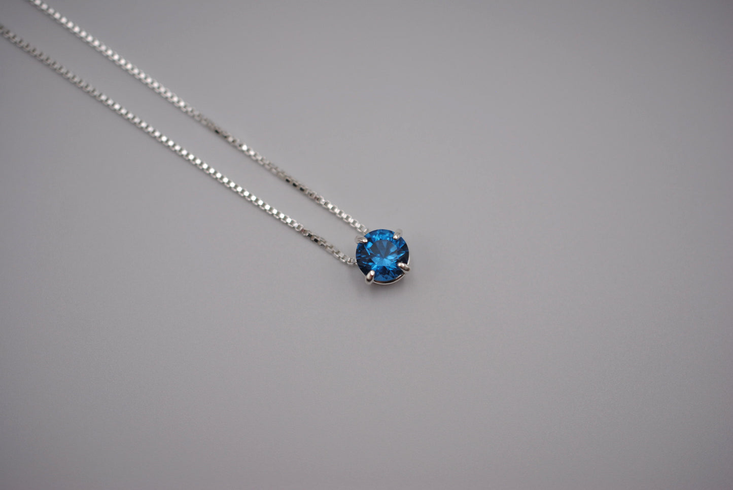 Birthstone Necklace: Round Blue Zircon, Silver Prong Setting, Adjustable Chain