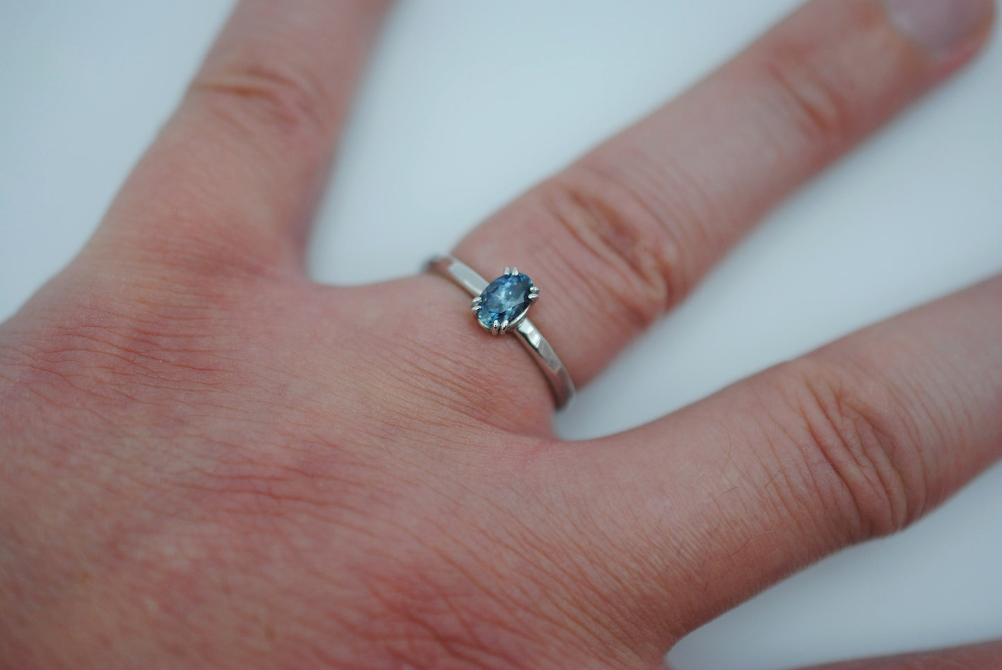 Sapphire Ring: Oval Cut, Hammered Band, Rhodium Finished