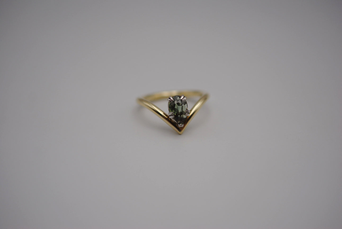 Sapphire Ring: Pear Cut, Green Gold Chevron Band, White Gold Setting
