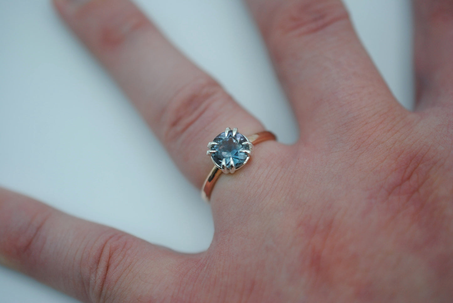 Blue Tourmaline Ring: Round Cut, Rose Gold Band, Silver Setting