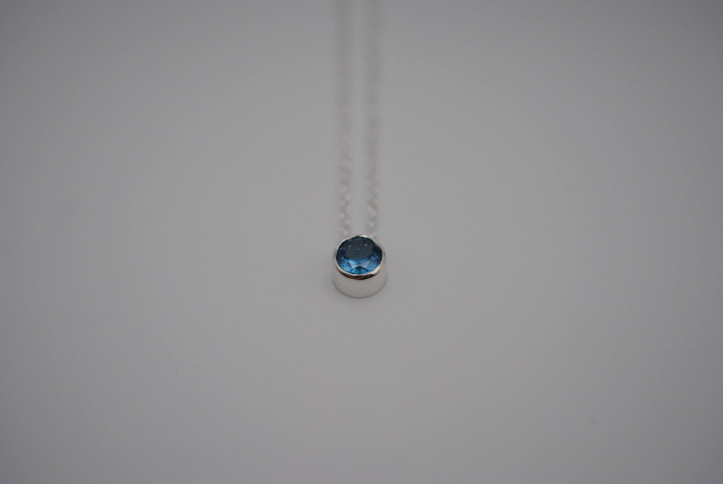 Birthstone Necklace: Round Blue Zircon, Bezel, Silver, Cable Chain