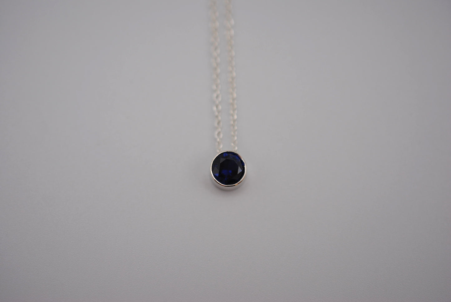 Birthstone Necklace: Round Sapphire, Silver Bezel, on Cable Chain