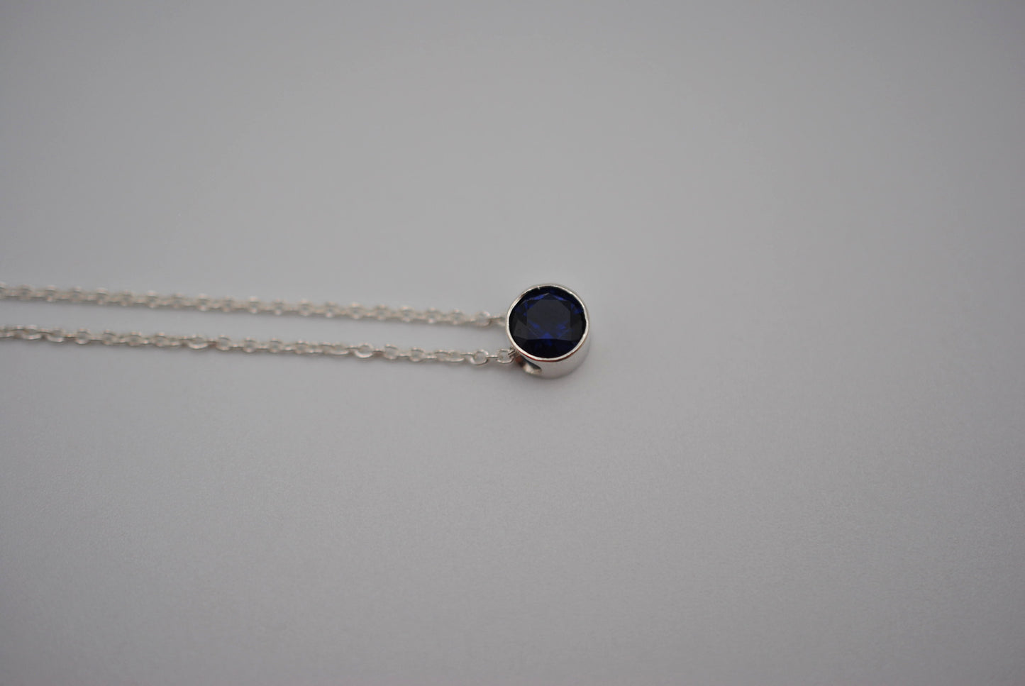 Birthstone Necklace: Round Sapphire, Silver Bezel, on Cable Chain