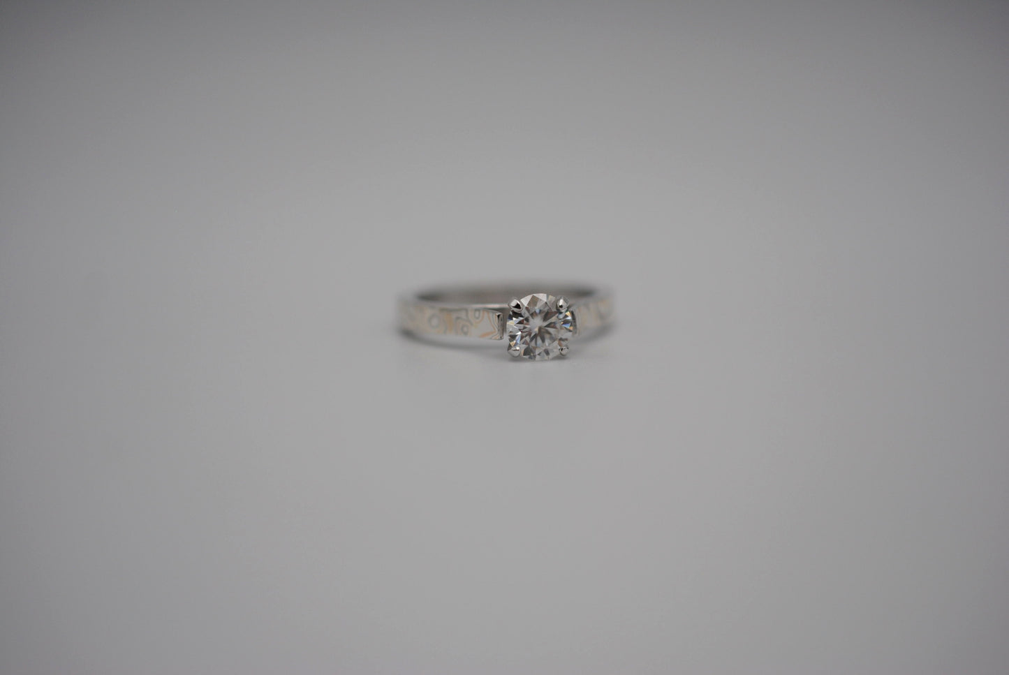 Moissanite Ring: Round Cut, Mokume Game Cathedral Band, White Gold Setting