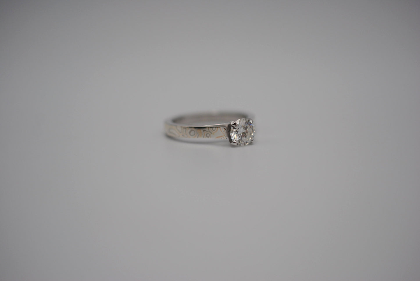 Moissanite Ring: Round Cut, Mokume Game Cathedral Band, White Gold Setting