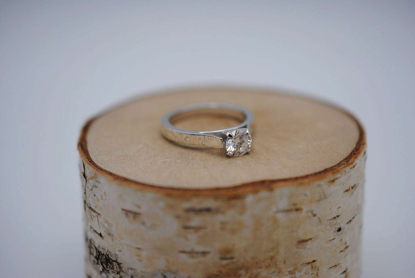 Moissanite Ring: Round Cut, Mokume Game Cathedral Band, White Gold Setting