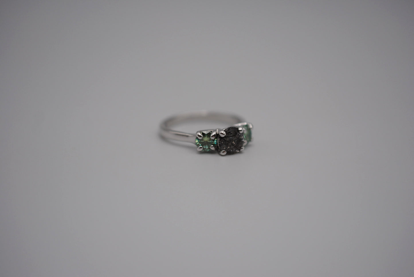 Rutilated Quartz Ring: Round Cut, Teal Moissanite Sidestones, Rhodium Finished