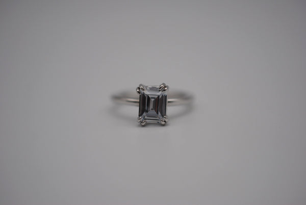 Emerald Cut Cubic Zirconia Solitaire Ring with Double Prong on Rhodium Finished Band