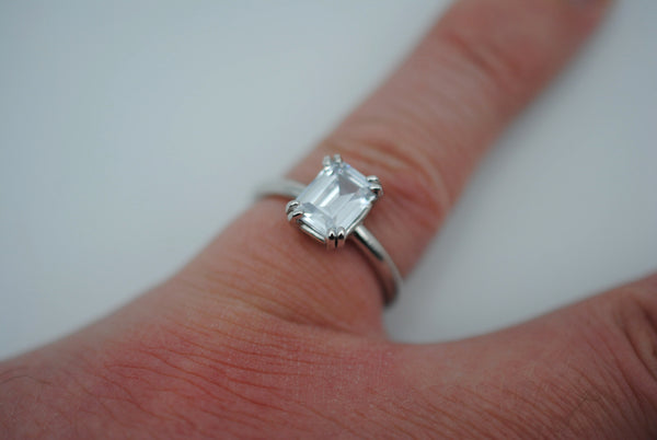 Emerald Cut Cubic Zirconia Solitaire Ring with Double Prong on Rhodium Finished Band